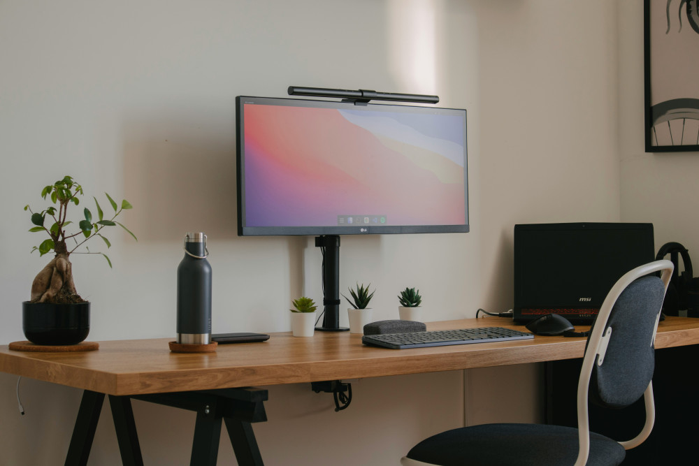 A desk on which objects such as a screen and a keyboard are placed.