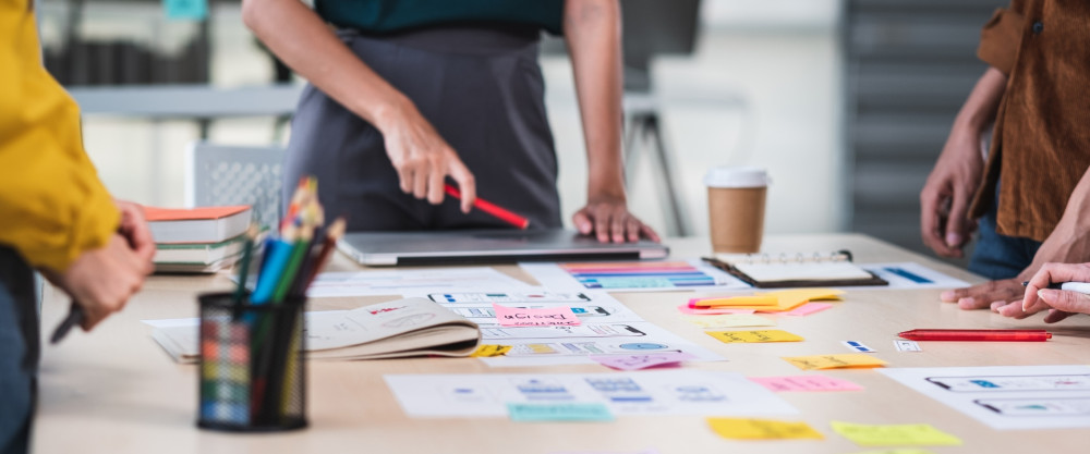 People working at a table with Post-Its and notes