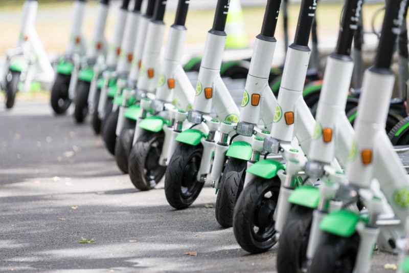 Numerous Lime scooters in a row