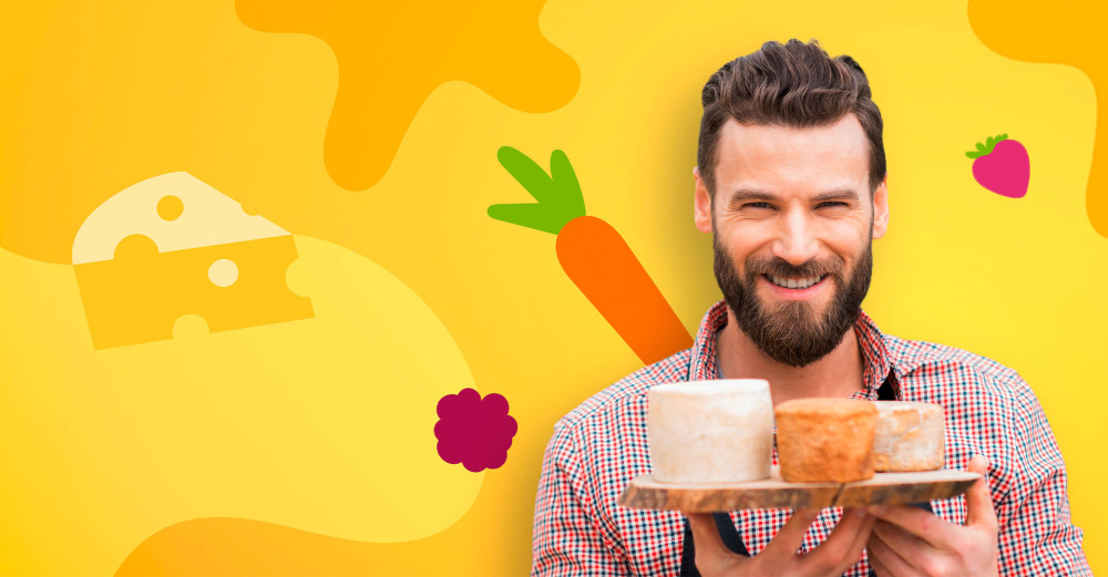 A man with a cheese plate in his hand stands in front of a wall in the design of the Thuringian quality label.