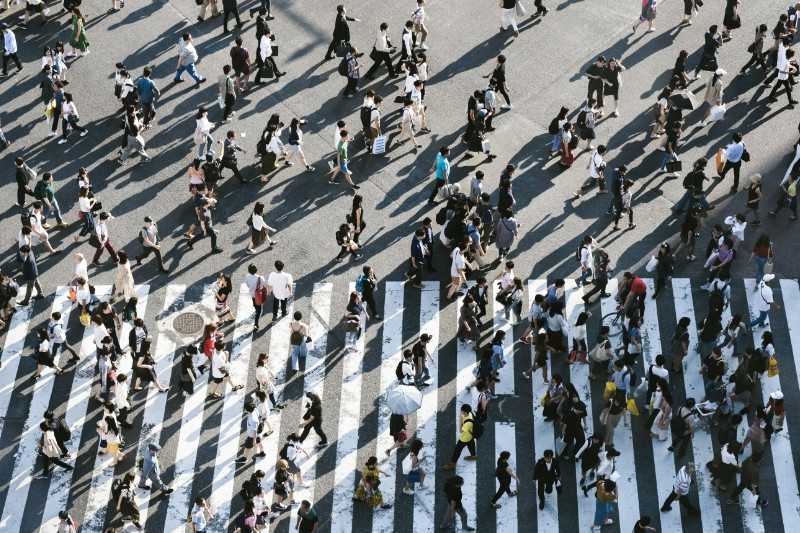 Viele Menschen, die einen Fußgängerüberweg überqueren